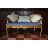 A Louis XV style double chair back carved giltwood window seat with double caned back and damask