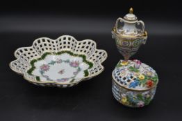 Three items of Dresden porcelain, a lidded pot, a pierced rim bowl and a Classical style lidded urn,