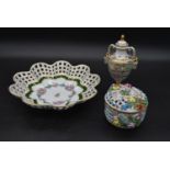 Three items of Dresden porcelain, a lidded pot, a pierced rim bowl and a Classical style lidded urn,