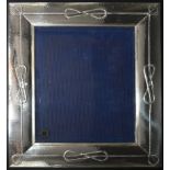 A large Italian silver easel picture frame with knotted cord and hammered decoration, marked