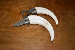Two antique warthog tusk bottle openers L.8cm