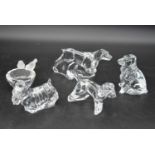A collection of four Baccarat crystal dogs to include a Scottish terrier and hunting dogs, all
