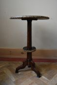 A 19th century amboyna and ebony occasional table with ormolu bound and geometric marquetry inlaid
