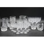 An extensive suite of cut crystal to include port and sherry glasses, champagne cups, vases, water
