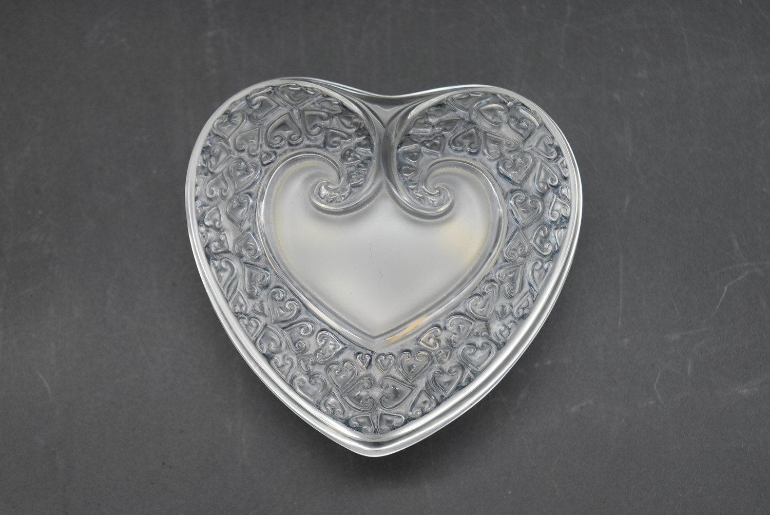 A boxed French Lalique heart shaped lidded frosted glass trinket box. Signed to base. With