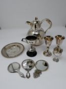 A collection of silver plated items; a hot water jug, trophy cups, card tray and hand mirrors (one