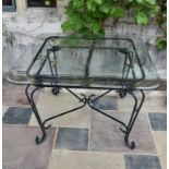 A wrought iron conservatory dining table with bevelled plate glass top. H.73 W.115cm