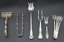 A miscellaneous collection of 19th century and later English silver flatware to include asparagus