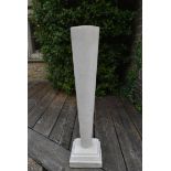 A tall stone tapering plinth on stepped base. H.105cm