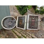 A pair of stain coloured etched and leaded glazed window frames and a similar window in circular