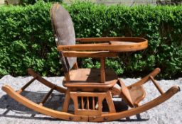 An antique beech framed metamorphic child's high chair converting to rocking chair.