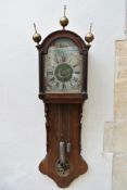 A 19th century Continental mahogany cased wall clock with brass finials and painted face with
