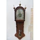 A 19th century Continental mahogany cased wall clock with brass finials and painted face with