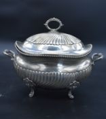 A 19th century Italian silver twin handled tureen and cover with half gadrooned shaped body and