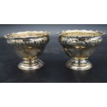 A pair of silver bowls with repousse Rococo decoration, hallmarked HA for Atkin Brothers, Sheffield,