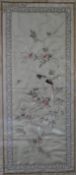 A Japanese framed and glazed silk work embroidery of a parakeet on a branch with blossom contained