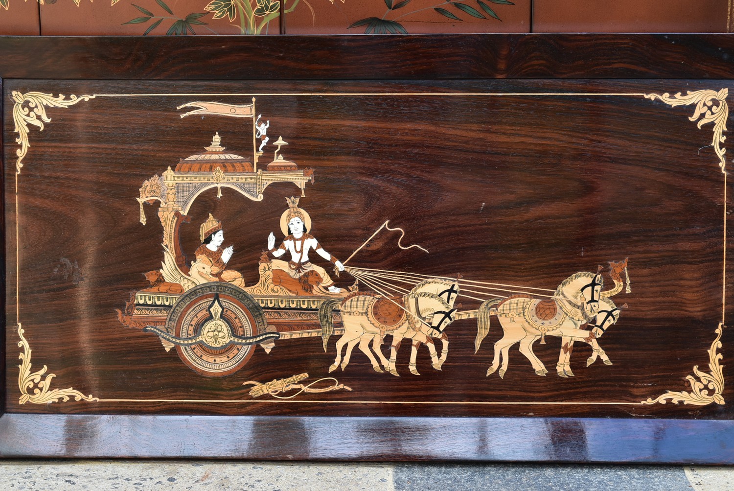 An inlaid Eastern rosewood panel depicting a couple in a ceremonial carriage in a rosewood frame. - Image 2 of 4