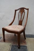 An Edwardian mahogany and satinwood salon chair with inlaid back splat and drop in seat on square