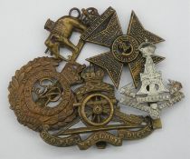 Five military cap and collar badges. Including a WW1 King's Royal Rifle Corps cap badge, a Royal