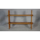 An Arts and Crafts light oak floor standing two tier open bookshelf. H.76.5 W.101.5 D.20.5cm