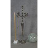 A large floor standing five branch chrome candelabra along with a crackle glass globe light filled