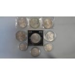 Nine silver coins in cases. Including a 1965 Sir Winston Churchill commemorative silver proof crown,