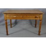 A Victorian pine two drawer side table on turned tapering supports. H.64.5 L.121 W.83cm