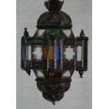 A Moorish design pierced metal hanging lantern with coloured glass panels. H.59cm