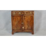 A late Georgian figured mahogany side cabinet with caddy top above a pair of drawers and panel doors