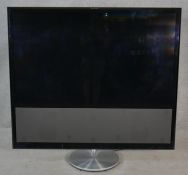 A Bang & Olufsen Beovision 10-54 Full HD LED TV with cables. H.121 W.129cm (As pictured) screen