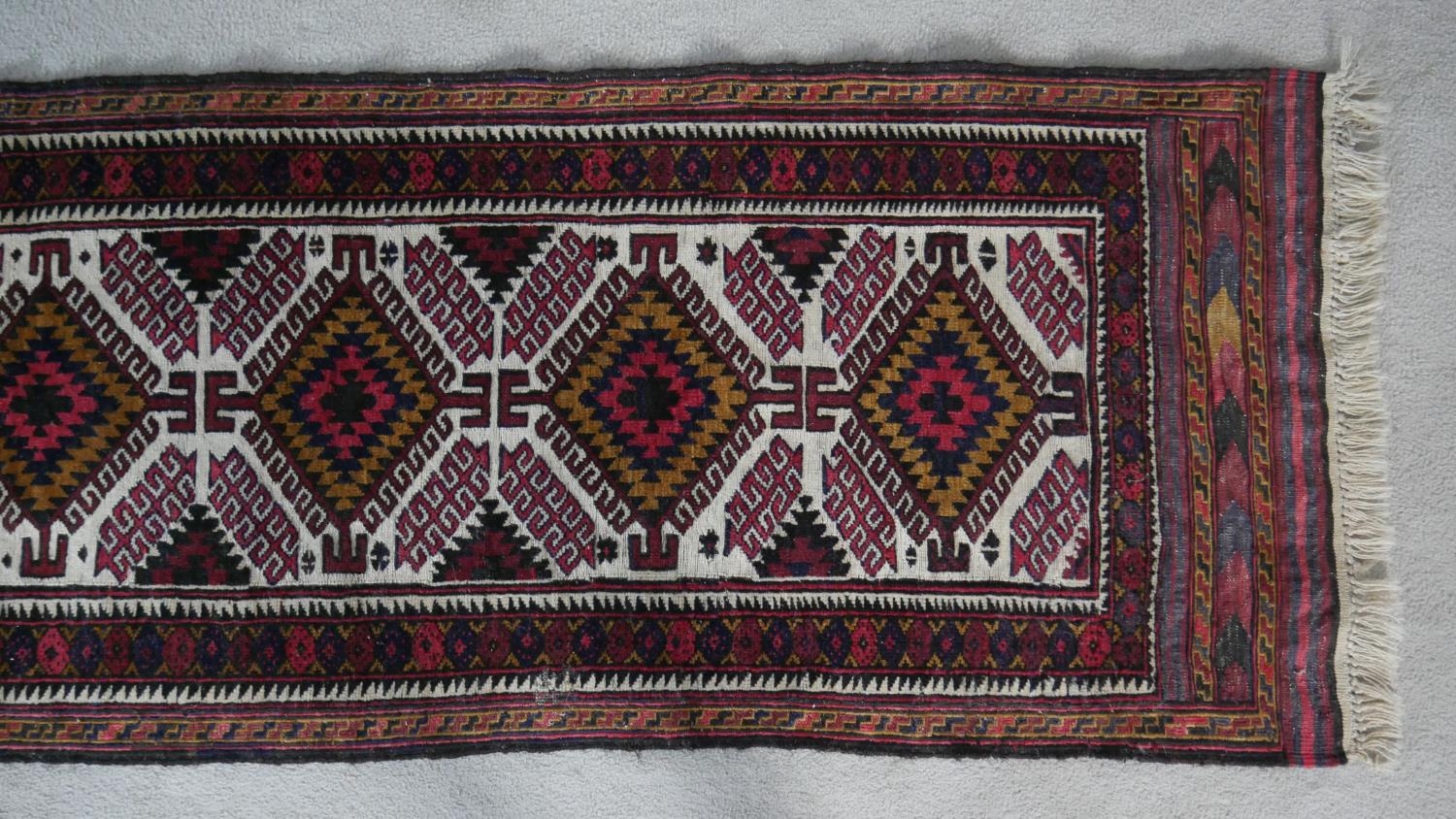 A Heriz runner with repeating hooked medallions on a fawn ground within geometric multiple - Image 2 of 4