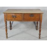 A 19th century mahogany writing table fitted with two deep frieze drawers on tapering ring turned