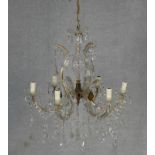 A vintage gilt metal and glass six branch chandelier with crystal drops and swags. W.60cm