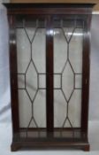 A Georgian style mahogany and satinwood inlaid and strung display cabinet with astragal glazed doors