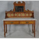 A late Victorian satin walnut washstand with carved and tiled mirrored upstand above marble top