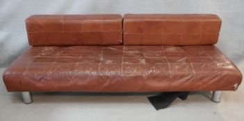 A 1970's vintage sofa in tan upholstery raised on tubular chrome supports with a pair of removable
