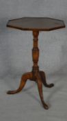 A Georgian elm occasional table with low galleried top on turned pedestal tripod base on cabriole