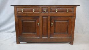A 18th century French Provincial oak side cabinet with pair of frieze drawers and central narrow