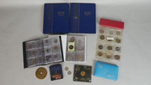 A miscellaneous collection of coins. To include a quantity of British pennies in two Whitman