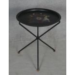 A folding toleware table with hand decorated armorial crest to the top. H.51.5 D.43.5cm