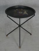 A folding toleware table with hand decorated armorial crest to the top. H.51.5 D.43.5cm