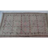 A Bakhtiar style carpet with repeating gull panels contained within a stylised floral border. L.