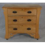 A late 19th century satin walnut chest of drawers with original Art Nouveau handles, carved frieze