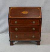 An Edwardian mahogany and satinwood crossbanded bureau with patera inlaid fall front revealing