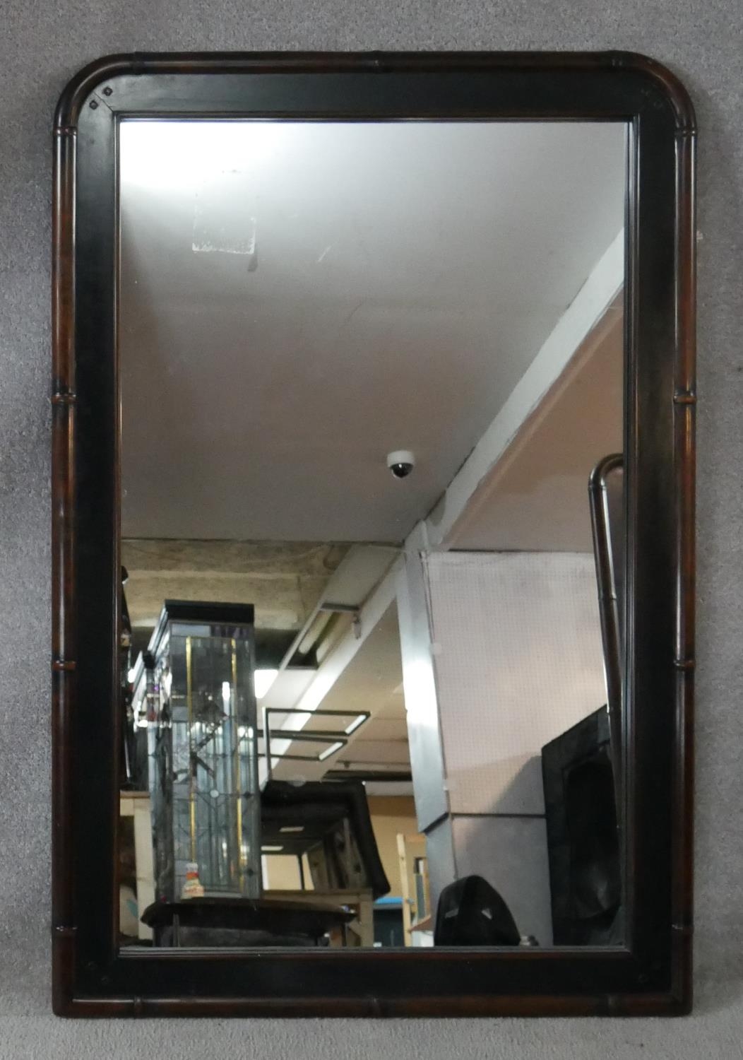 A black lacquered overmantel mirror in faux bamboo style frame. H.120 W.80cm