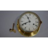 A Schatz Royal Mariner brass cased ship's clock, two train eight day movement with key. D.17cm