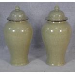 A pair of Chinese crackle glazed lidded temple jars with character marks to the bases. H.65cm