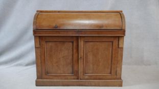 A 19th century mahogany cylinder top bureau with fitted interior and pull out leather inset