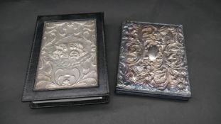 Two leather silver fronted note books, one with repousse floral decoration hallmarked: JBLd for John