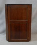 A 19th century oak wall hanging corner cupboard. H.104 W.73.5 D.40cm